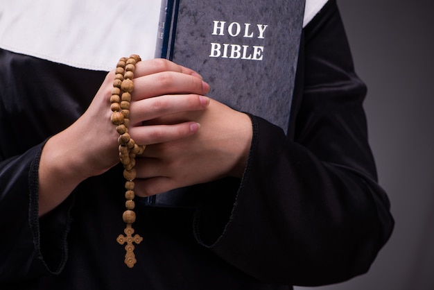 Religious nun in religion concept against dark background