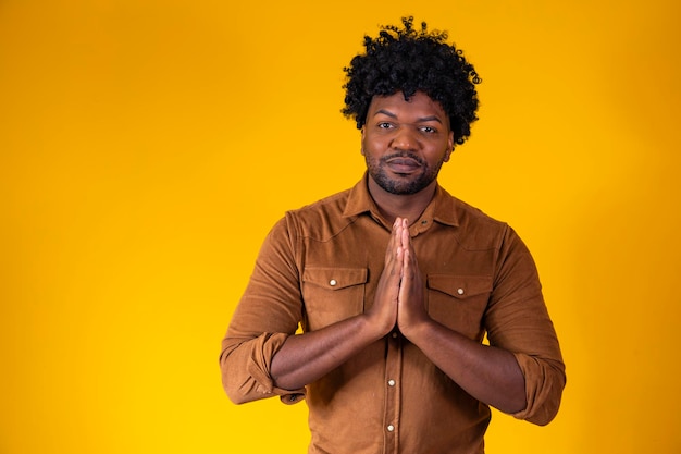 Religious young afro man praying to God