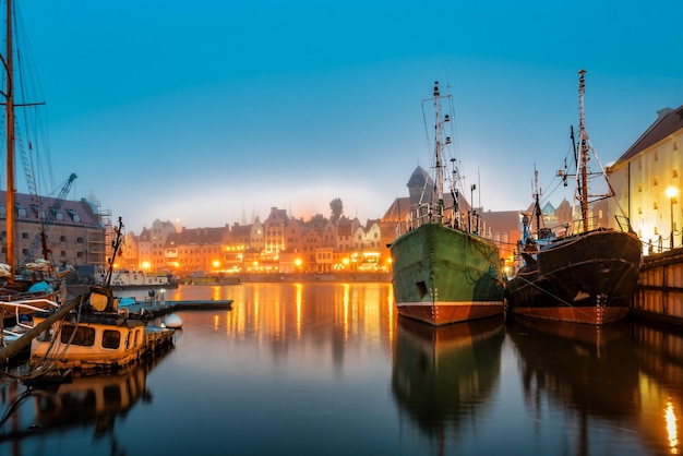 The remains of a sunken ship and two old ships in the sity port