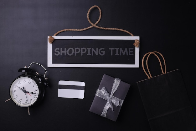 Reminder for shopping time at black friday sale event Black stuff flat lay on black background