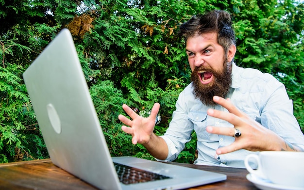 Remote job freelance professional occupation hipster busy with\
freelance wifi and laptop slow internet irritating drink coffee and\
work faster deadline is coming bearded man freelance worker