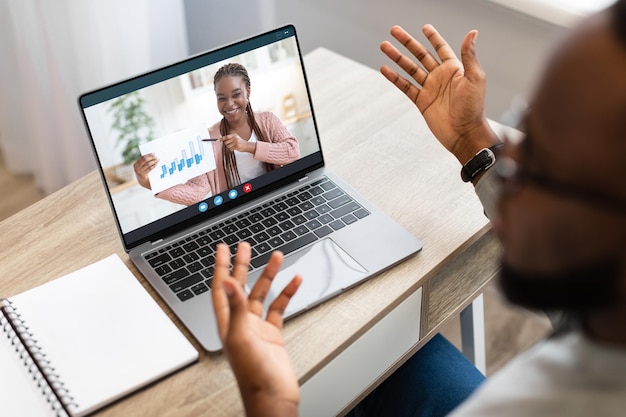 Photo remote meeting man having web conference on laptop with female business partner