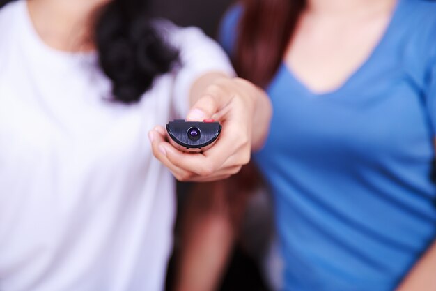 remote tv in hand of woman