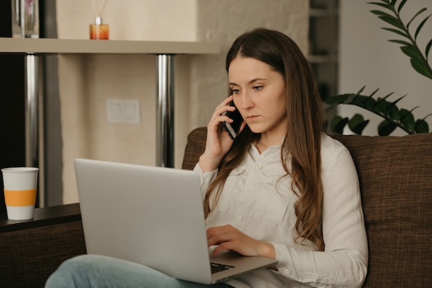 Remote work. A caucasian woman working remotely on her laptop.