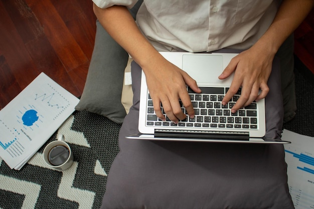 Remote work concept Male freelancer use laptop to typing business data and working in living room