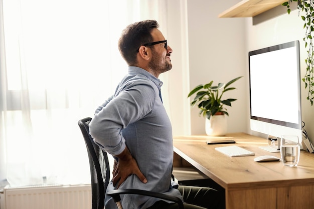 A remote worker is having back pain while sitting at his home office