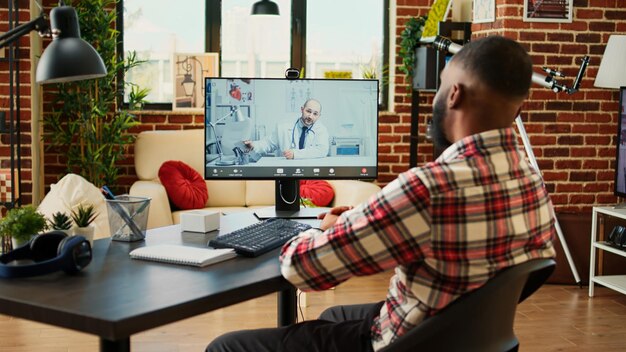 Photo remotely working employee in telemedicine video call asking for medical advice teleworker in online consultation with doctor doing checkup after staying home for too long