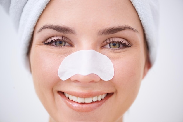 removing blackheads in one quick pluck a young woman with a nose strip on