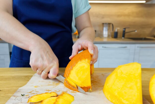 Removing the skin from pumpkin with knife