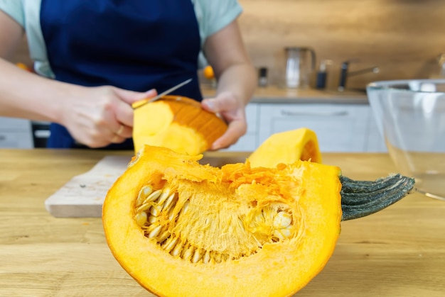 Removing the skin from pumpkin with knife