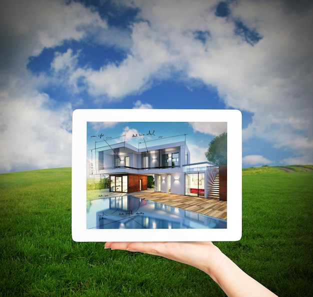 Rendering of project of new house in a tablet screen with meadow