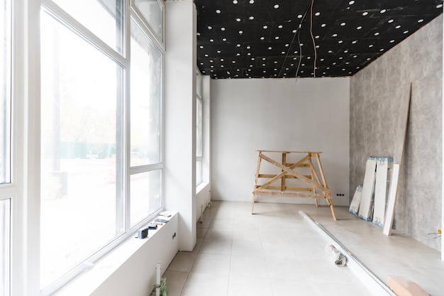 Renovated room with shopping window - empty store shop with\
wooden floor and white walls