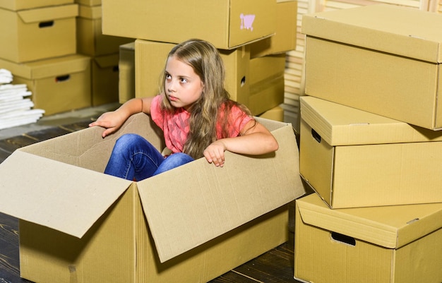 Rent a convertible not a moving truck happy child cardboard box\
purchase of new habitation cardboard boxes moving to new house\
moving concept new apartment happy little girl