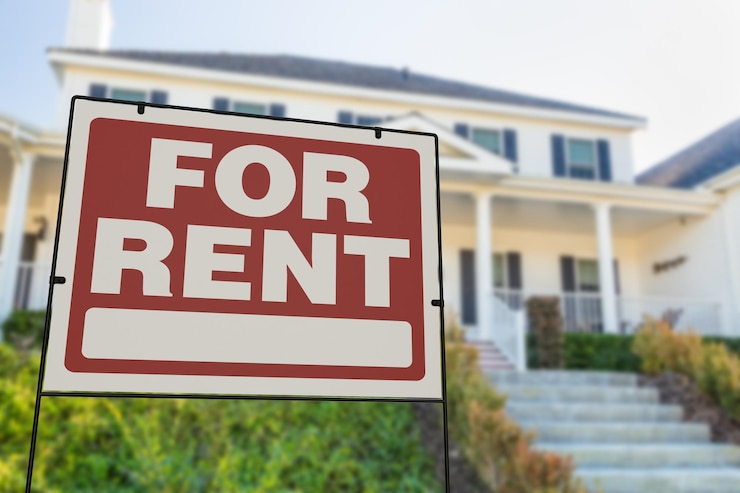 Photo for rent real estate yard sign in front of house