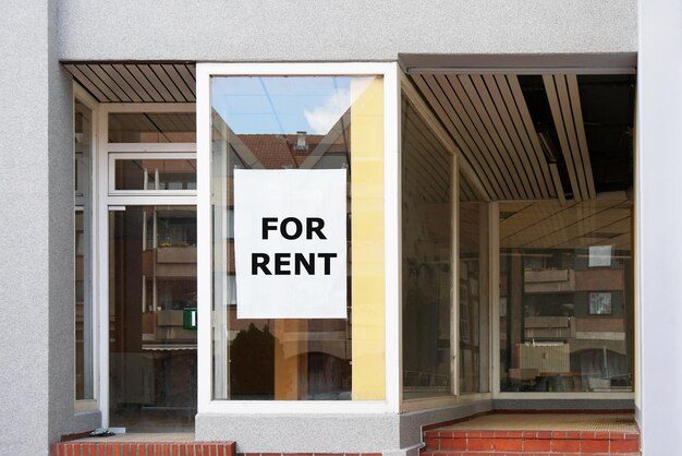 Photo for rent sign in empty shop window