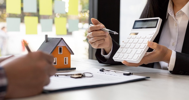 A rental company employee is calculating the cost for the customer to agree to sign a rental contract explaining the rental terms and conditions Home and real estate rental ideas