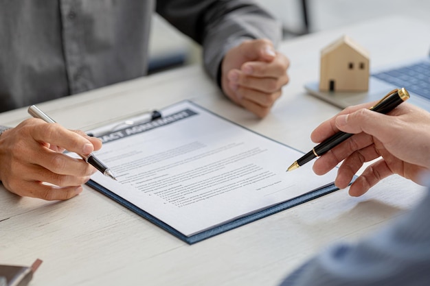 Rental company employee is discussing the details before the\
customer agrees to sign a rental contract explaining the details\
and the terms and conditions of the rental real estate rental\
ideas