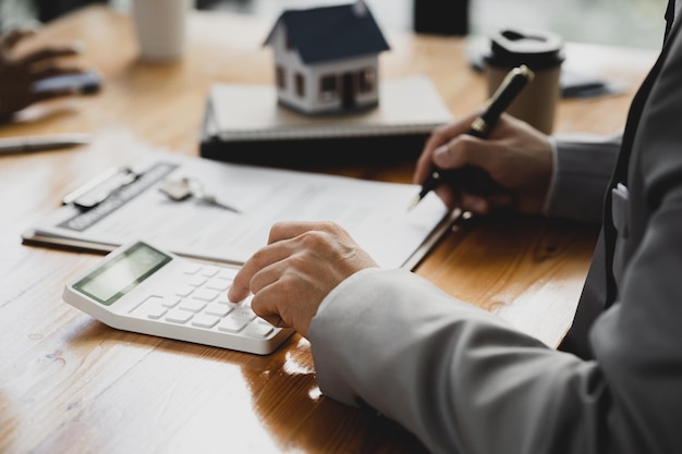 Rental company employee is discussing the details before the customer agrees to sign a rental contract explaining the details and the terms and conditions of the rental Real estate rental ideas