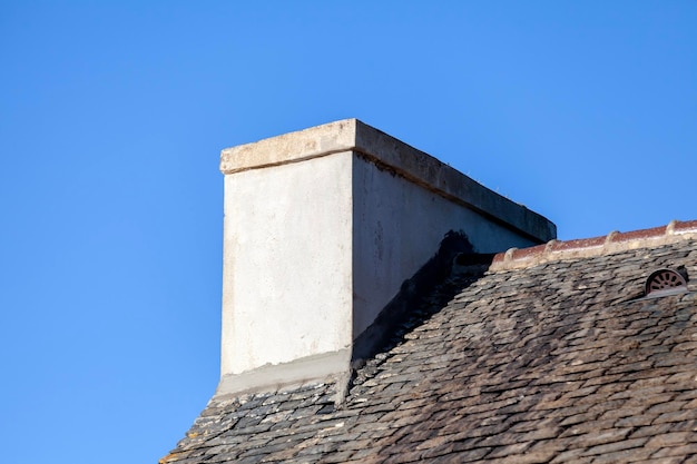 Photo repair of a chimney flashing on an old slate roof