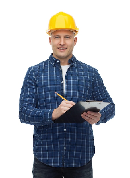 repair, construction, building, people and maintenance concept - smiling male builder or manual worker in helmet with clipboard taking notes