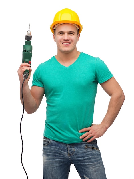 repair, construction and maintenance concept - smiling male manual worker in protective helmet with drill machine