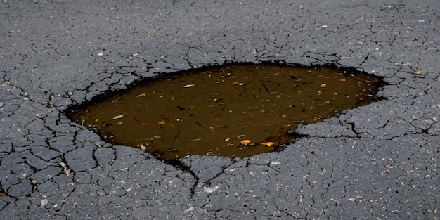 Repair crews will soon address the pit and its watery inconvenience on the road