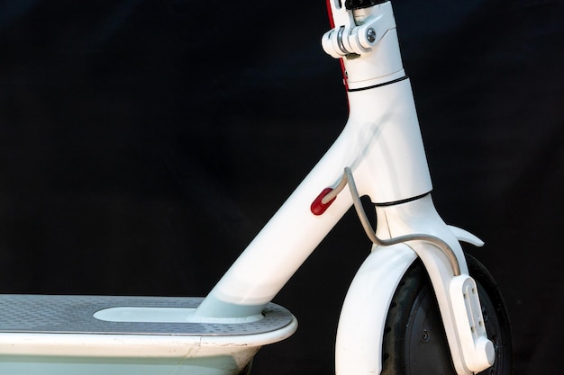 Repair of an electric scooter a modern white scooter with an\
electric motor broken electrical equipment in the workshop