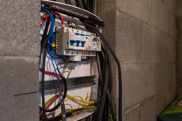 Repair of electrical switchgear. an electrician replaces old\
electrical wiring devices.