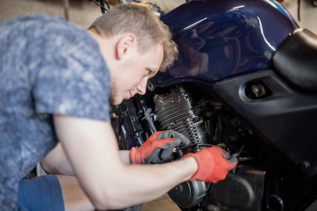 repair and maintenance of a motorcycle in a garage by a man