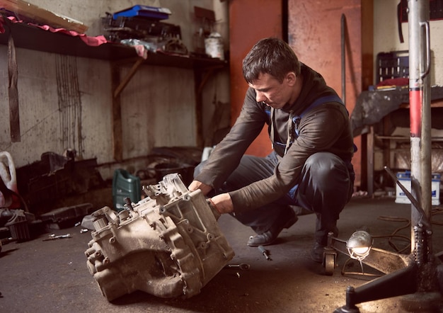 Photo repair man fixing car in repair station