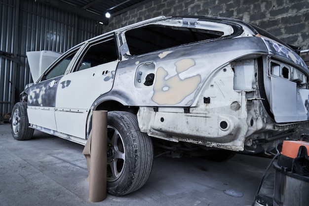 Repair of an old broken car at auto service