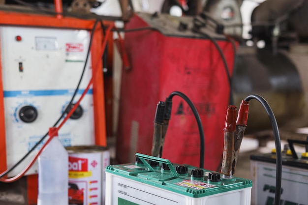 In the repair shop, a battery charger is in use.