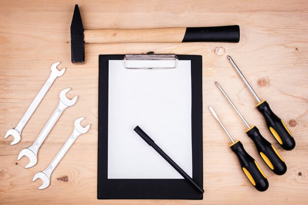 Repair tools - hammer, screwdrivers, adjustable wrenches, pliers. Sheet of white paper. Male concept for father's day