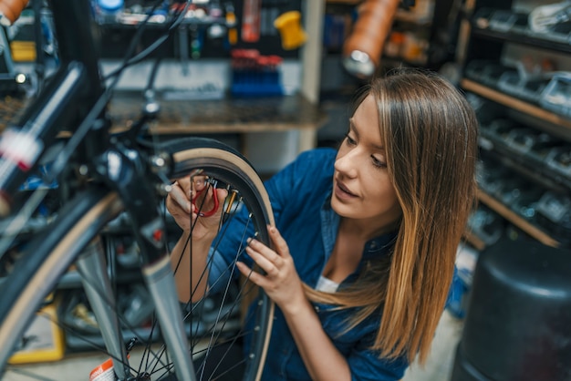 Repairing her bike. 