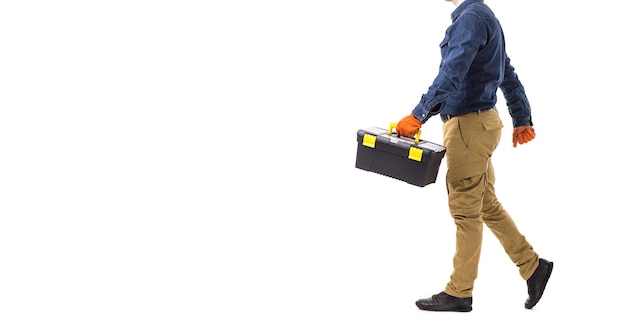 Repairman builder holds the tool box in his hand isolated on white background with copy space