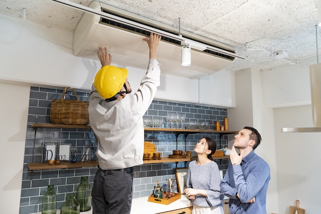 A repairman checking the air conditioner