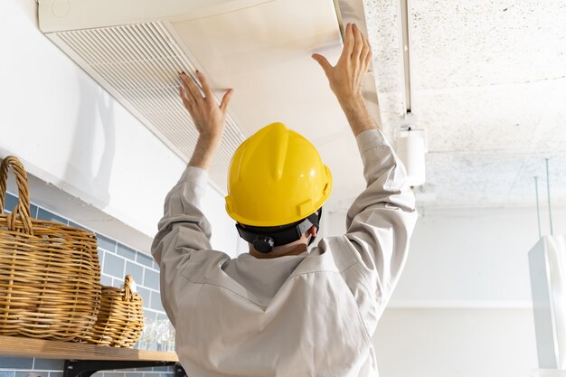 A repairman checking the air conditioner