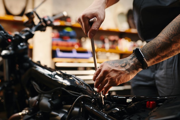 Repairman fixing motorcycle part