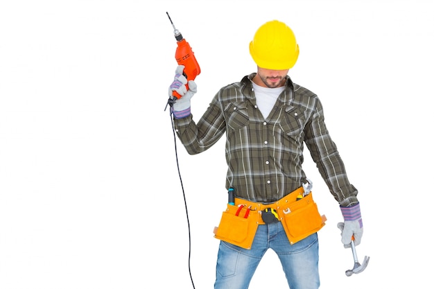 Repairman holding hammer and drill machine