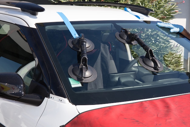 Repairman is repairing windshield of the car