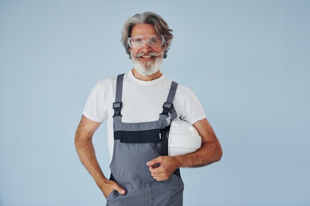 Repairman ready for work Senior stylish modern man with grey hair and beard indoors