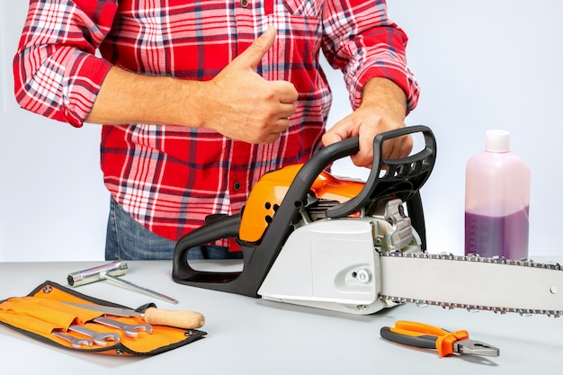 Photo repairman with chainsaw giving a thumbs up