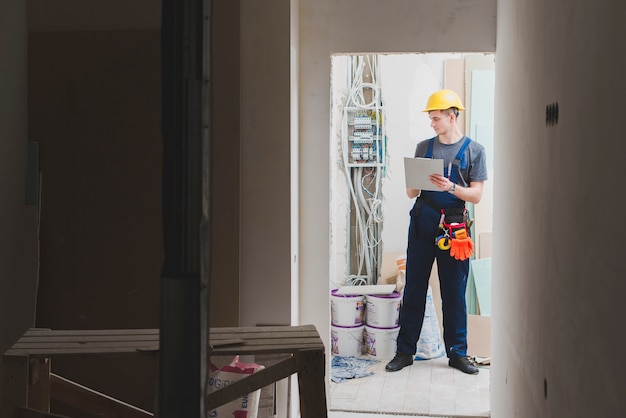 Repairman with tablet on site