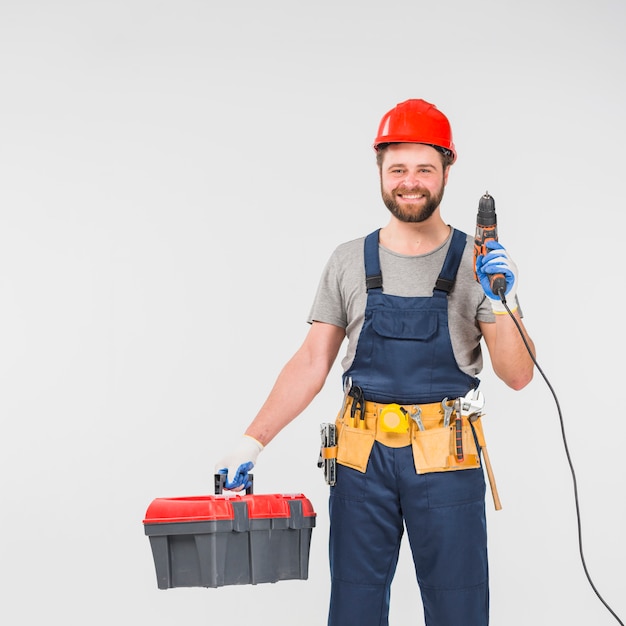 Repairman with tool box holding drill 