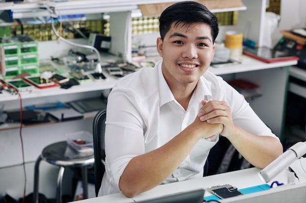 Repairman working at smartphone repair shop