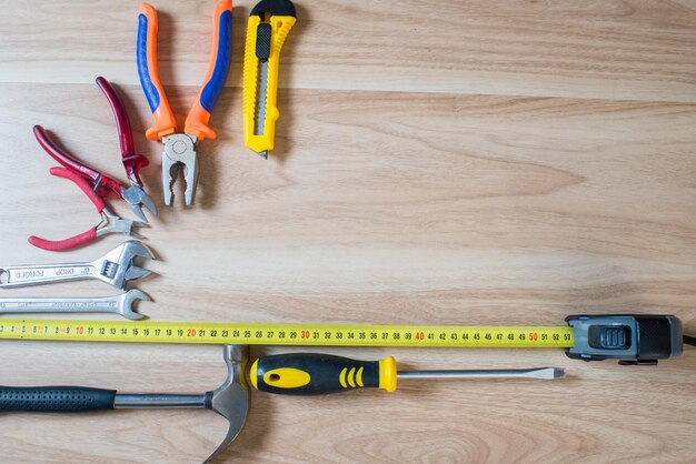 Repairs or construction tools on wooden background