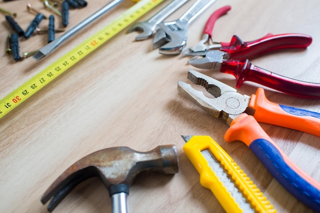 Repairs or construction tools on wooden background