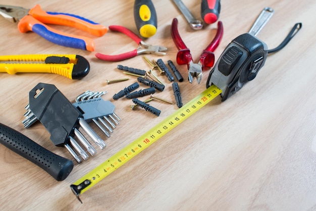 Repairs or construction tools on wooden background