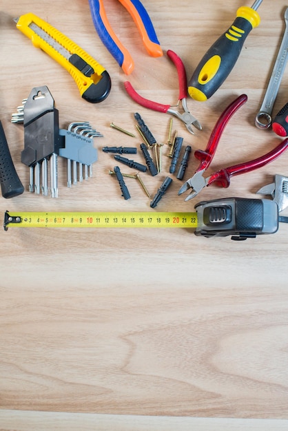 Repairs or construction tools on wooden background