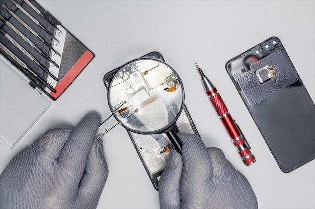 Reparateur repareren Smartphone met pincet Kleine onderneming thuis